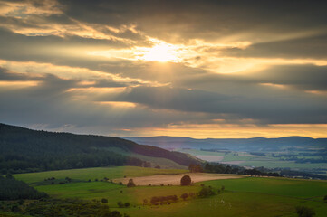 The Sun goes down over Cheviot Hills, viewed from Simonside Hills near Rothbury in Northumberland National Park across Coquetdale
