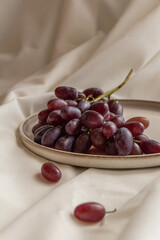fresh juicy grapes on a plate on a light background