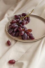 fresh juicy grapes on a plate on a light background