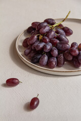 fresh juicy grapes on a plate on a light background