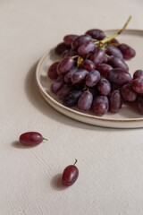 fresh juicy grapes on a plate on a light background