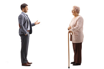 Full length profile shot of a man in a suit talking to his elderly mother