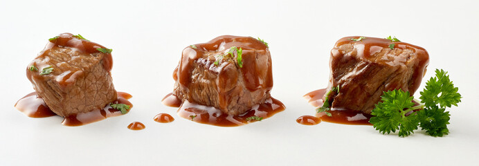 Three individual cubes of beef goulash in gravy