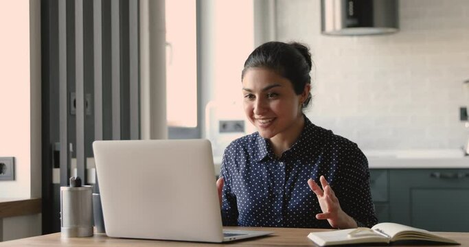 Indian woman applicant pass job interview by videocall and laptop received positive answer got hired feels happy. Businesswoman sit at desk enjoy good conversation through video conference app concept
