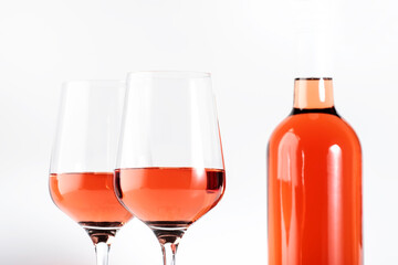 Rose wine glass with bottle on the white table. Rosado, rosato or blush wine tasting in wineshop, bar concept. Copy Space
