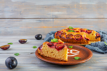 Delicious homemade plum pie on wooden background