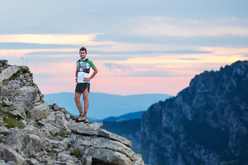 Obraz premium Athlete Runner Runs Rocks In Mountain