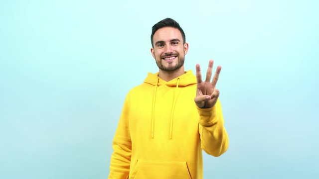 Young caucasian man showing number three, symbol of counting, concept of mathematics, confident and cheerful