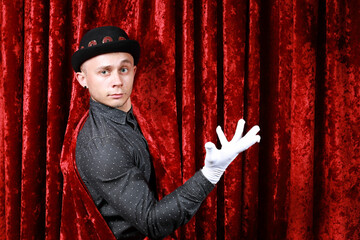 master ceremony on the stage in white gloves at red background