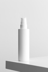 White cosmetic lotion bottle mockup on a white table.