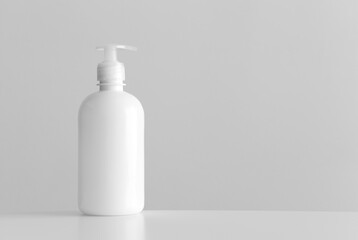White cosmetic liquid soap dispenser bottle mockup with blank copy space on a white table.