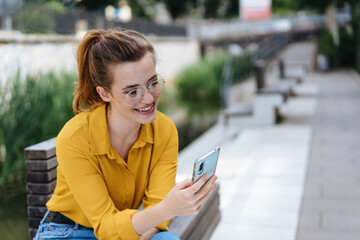 Woman looking at smartphone in urban background
