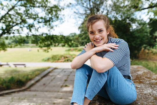Happy relaxed young woman in a park in summer