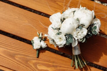 Wedding white bouquet on wooden bench