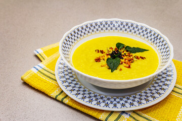 Corn cream soup with fresh vegetables, herbs and spices