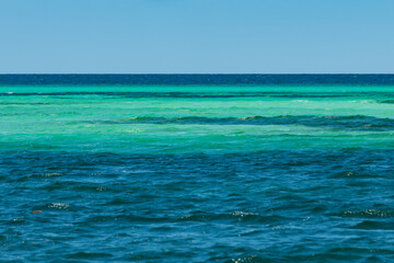 Fototapeta na wymiar Sea water with amazing color from deep blue to light turquoise