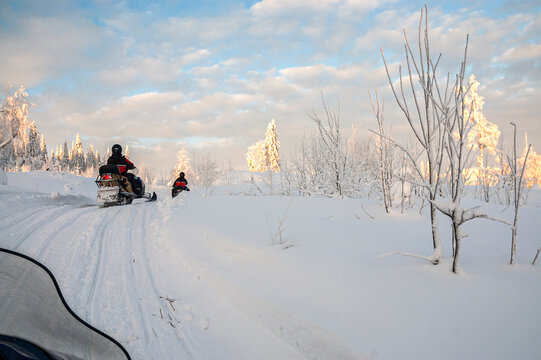 A winter ride on a snowmobiles, winter landscape and snowmobile track, Vuokatti, Finland