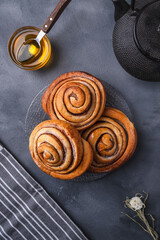 Cinnamon buns with honey.  Fresh pastry. Top view.