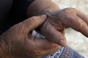 Fototapeta na wymiar Elderly woman suffering from hand pain. Arthritis symptoms.