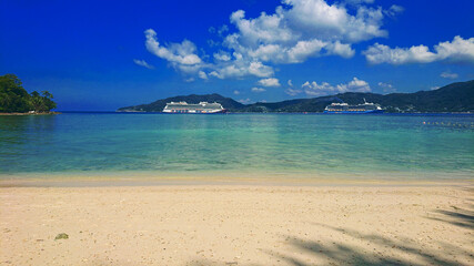 Quiet Paradise Beach located near Patong, in Phuket Island Thailand with golden sand, azure water and palm trees. 