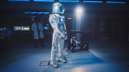 Low Angle Shot of an Astronaut Space Suit Adapted for Space and Travel Exploration Standing in an Aerospace Development Laboratory. Scientists and Engineers