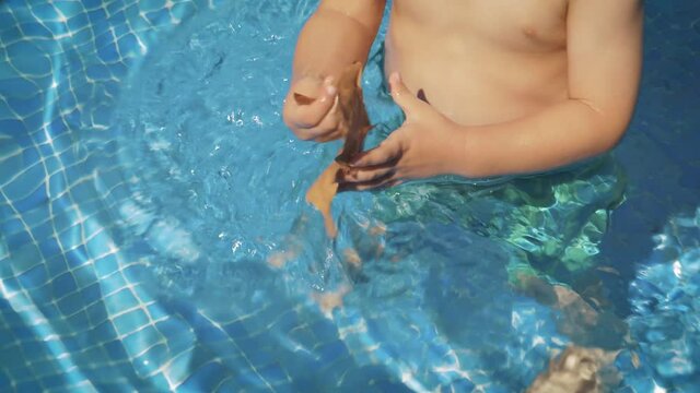 Last day of summer and back to school conceptual photo. A leaf is swimming at the pool as a reminder of coming autumn soon.