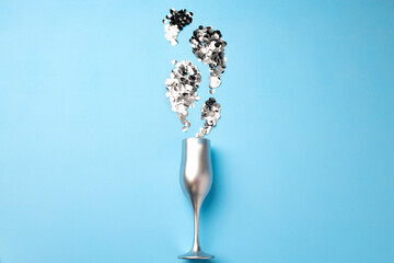 Champagne glass with confetti flat lay top view