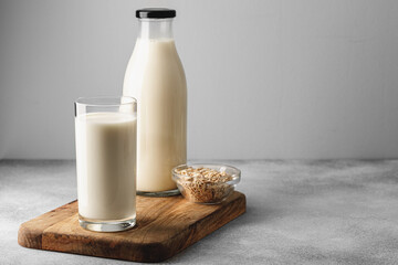 Vegan oat milk with oat flakes close up