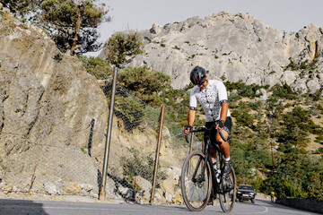 Professional road bicycle racer in action on mountain road