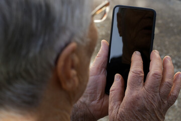 Elderly caucasian woman using cell phone.