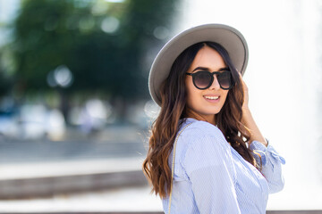 Beautiful young girl walking in the city.