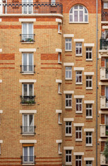 facade of an old building with a brick pattern in Paris
