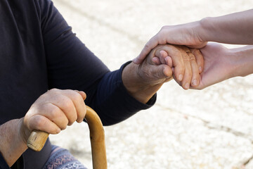 Holding hands. A picture of young and old hands. Concept of hope, care, love and support.