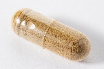 Close up brown herbal medicine capsule