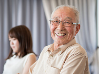 An old man talking animatedly at a family event