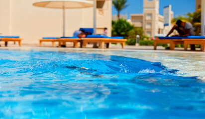 Fototapeta na wymiar splash of water in the pool at sunny day