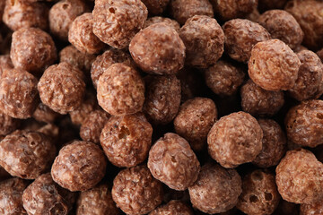 Chocolate corn balls on whole background, close up
