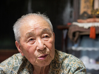 An old man talking to someone off camera