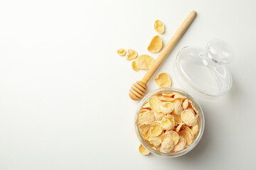 Dipper and jar of muesli on white background