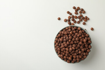 Bowl with corn balls on white background, top view