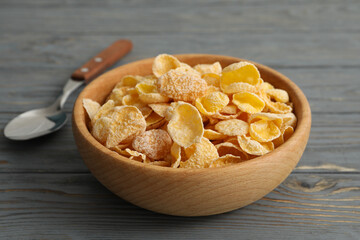 Spoon and bowl of muesli on wooden background