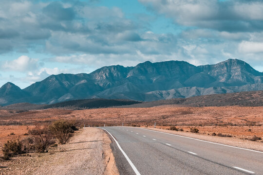 Ikara Flinders Ranges National Park. Panorama road heading to the mountains. No cars, no people in the picture. Dramatic cloudy sky. Aboriginal name: Ikara. Nature in South Australia.