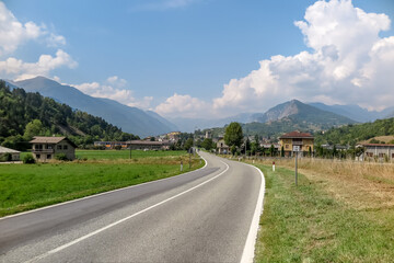 Fototapeta na wymiar Asphalted road towards the Alpes-Maritimes, Piedmont region, Cuneo province, Italy