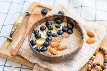 Healthy breakfast berry smoothie bowl topped with banana
