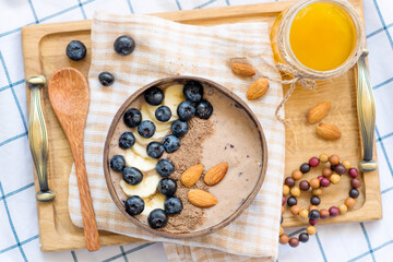 Healthy breakfast berry smoothie bowl topped with banana