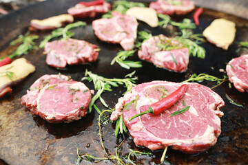 meat pork with red chili pepper, rosemary cooking on pan