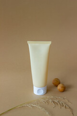 Cosmetic cream in a tube on a beige background. Natural cosmetics. Skincare. Mock-up. Copy space.
