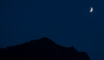 Night sky with half moon and silhouette of  the mountainous landscape from Seoraksan National Park in Sokcho, South Korea. 