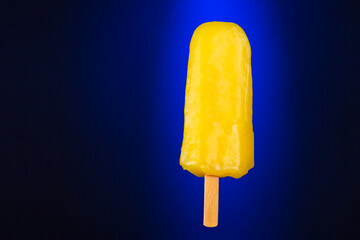 Refreshing orange sorbet in a studio shot isolated over blue degraded background.