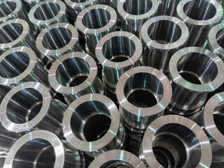 abstract industrial shiny steel production stack background with cnc machined pipes - selective...